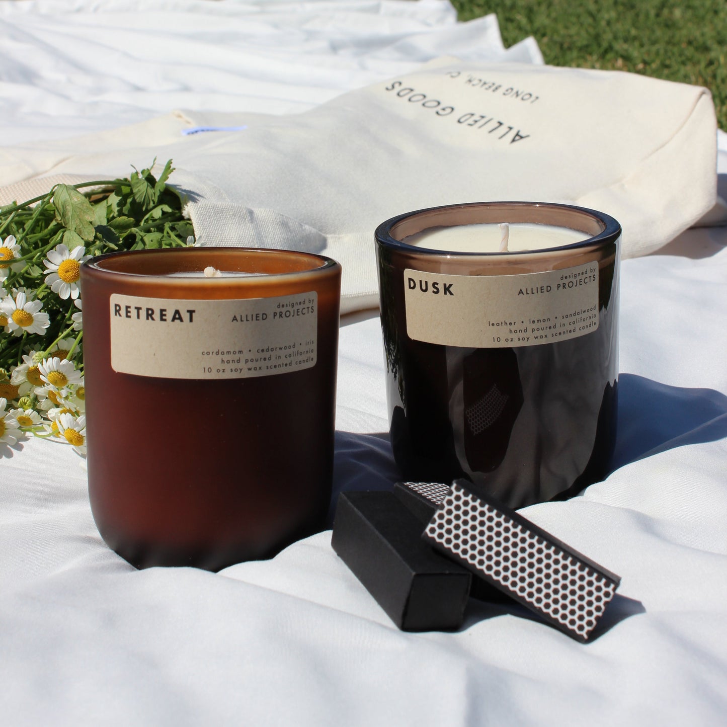 Sustainable, hand-poured candles for spring—Retreat and Dusk offer a luxurious, eco-friendly burn. Retreat blends spicy cardamom, rich cedarwood, and delicate iris for a grounding aroma, while Dusk evokes depth and sophistication with warm sandalwood, smooth leather, and a refreshing hint of lemon. Crafted with natural wax for a clean burn, perfect for mindful relaxation and cozy evenings.