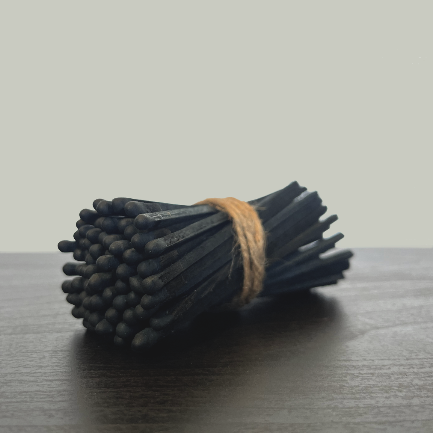 bundle of black matches wrapped in twine