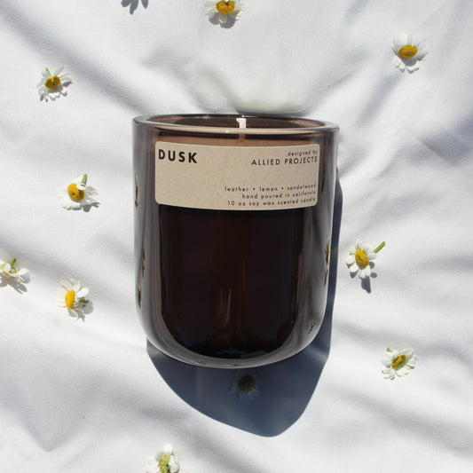 A handcrafted, eco-friendly candle designed for those who love deep, moody scents. This luxury, hand-poured candle features a sophisticated blend of warm sandalwood, rich leather, and a refreshing hint of lemon, creating a bold yet smooth aroma perfect for evening relaxation. Made with natural, sustainable wax and a clean-burning, non-toxic formula, Dusk enhances any space with its refined and grounding fragrance.