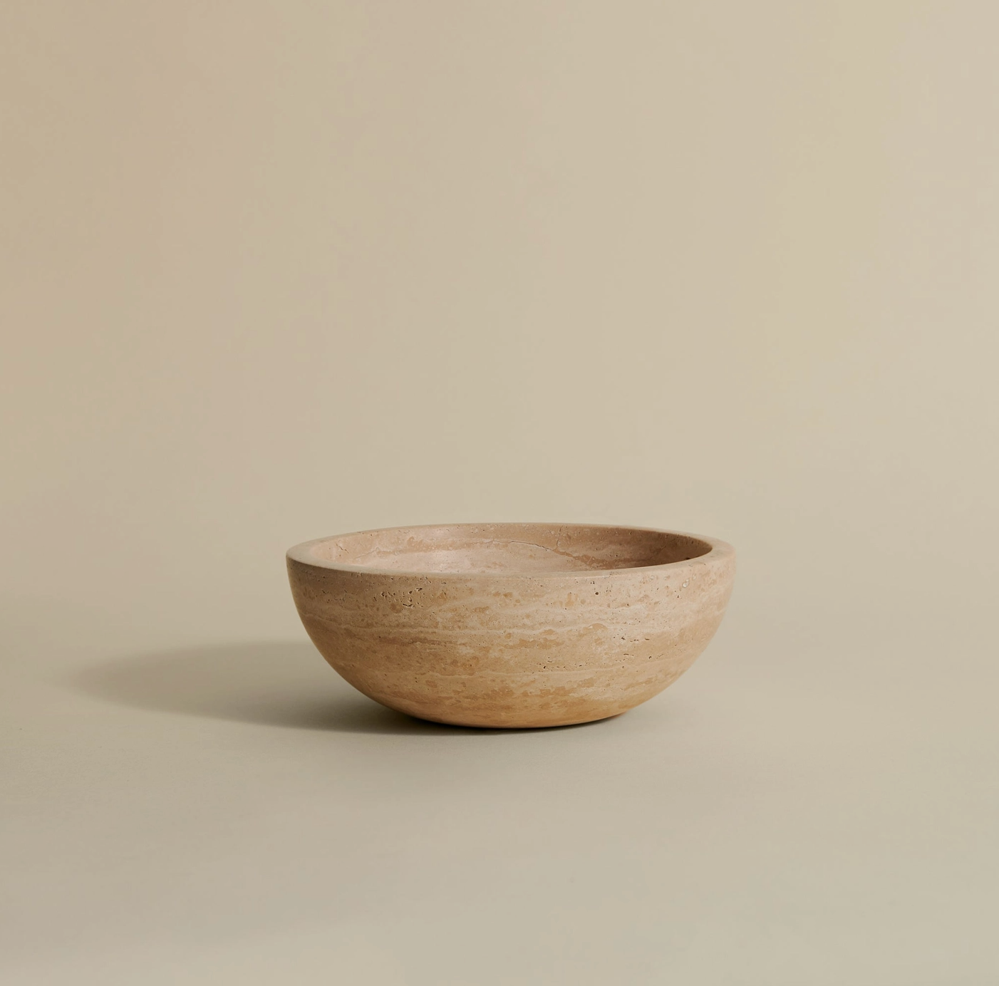 Natural travertine stone bowl with smooth finish, ideal for modern decor.